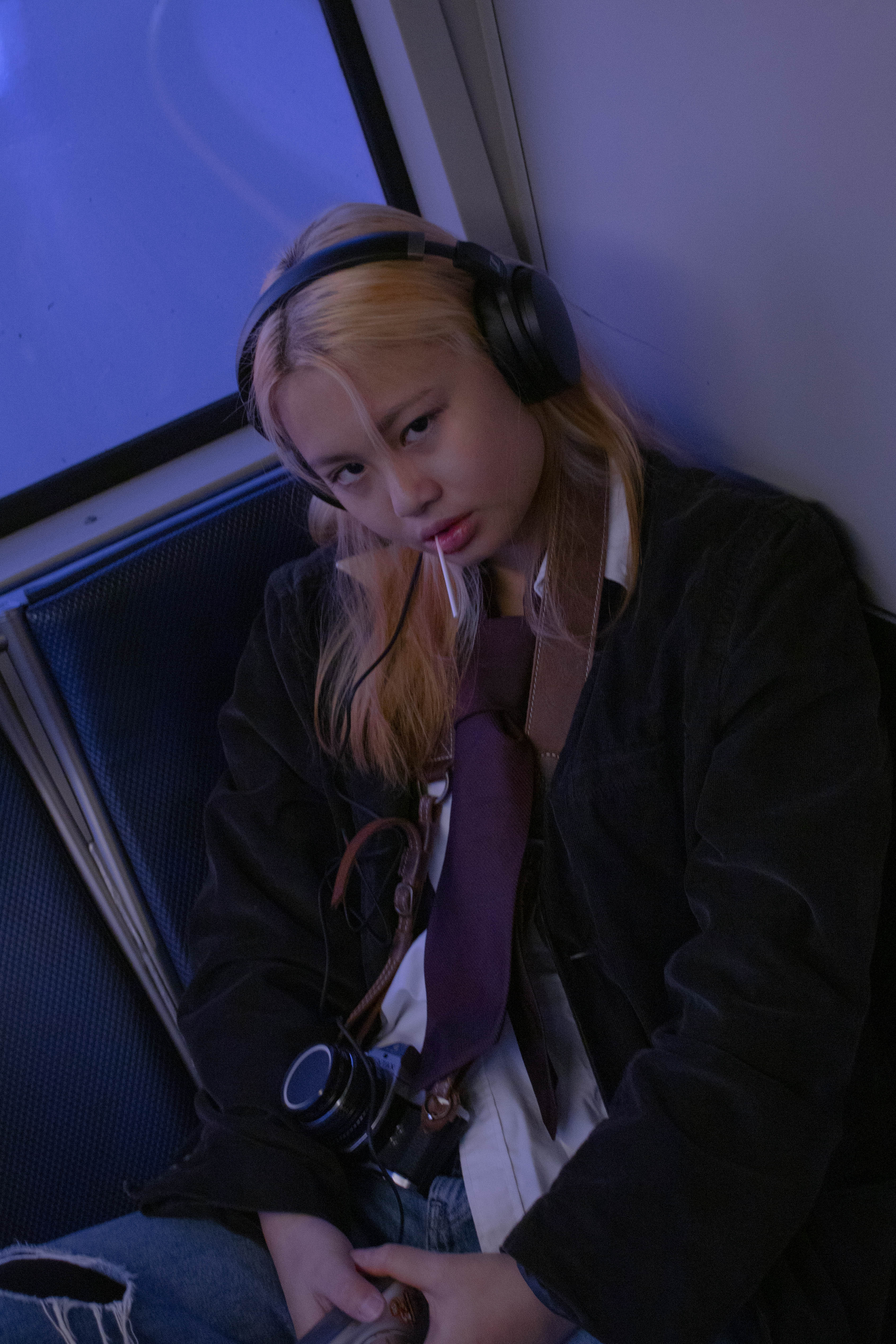 A picture of Alexis on the bus with headphones on